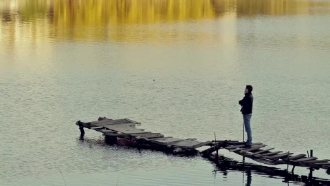 Stock Video Man Appreciating A Lake On A Worn And Broken Pier Animated Wallpaper - Free Live Wallpaper