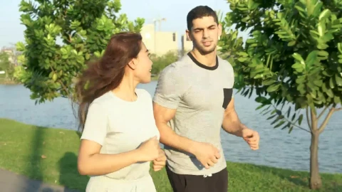 Stock Video Man And Woman Running Through A Sunny Park Animated Wallpaper - Free Live Wallpaper