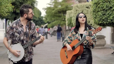 Stock Video Male And Female Friends Walking Through A Park While Playing Animated Wallpaper - Free Live Wallpaper