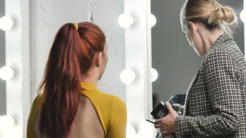 Stock Video Makeup Artist Putting Makeup On A Model In Front Of Animated Wallpaper - Free Live Wallpaper
