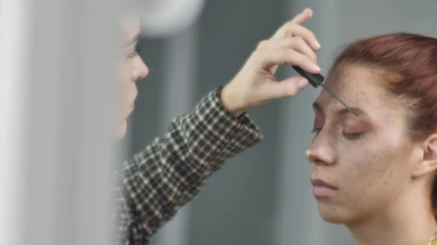Stock Video Makeup Artist Putting Makeup On The Eyebrows Of A Young Animated Wallpaper - Free Live Wallpaper
