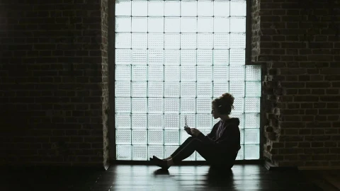 Stock Video Lonley Girl Sitting On Floor With Headphones Backlit By Window Animated Wallpaper - Free Live Wallpaper