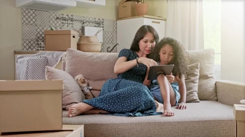 Stock Video Mom Teaching Something To Her Daughter On A Table Animated Wallpaper - Free Live Wallpaper