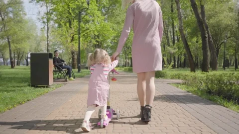 Stock Video Mom Leads Daughter On Scooter Through Par Animated Wallpaper - Free Live Wallpaper