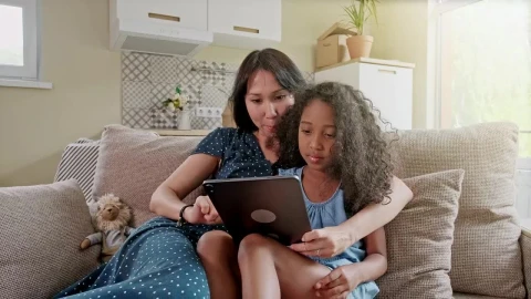 Stock Video Mom And Daughter Use Tablet On Sofa In New Apartmen Animated Wallpaper - Free Live Wallpaper
