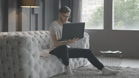 Stock Video Millennial Man Working In Minimalist Living Roo Animated Wallpaper - Free Live Wallpaper