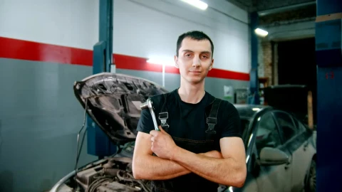 Stock Video Mechanic Holding A Repair Tool With A Broken Car I Animated Wallpaper - Free Live Wallpaper