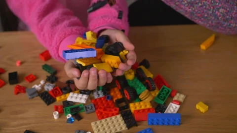 Stock Video Many Lego Pieces Falling Into The Hands Of A Gir Animated Wallpaper - Free Live Wallpaper