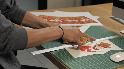 Stock Video Mans Hands Cut A Printed Illustration With A Cutte Animated Wallpaper - Free Live Wallpaper