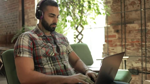 Stock Video Man Works On Laptop With Headphones In Coworking Spac Animated Wallpaper - Free Live Wallpaper