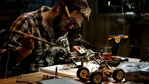 Stock Video Man With Glasses Soldering A Drone In The Garag Animated Wallpaper - Free Live Wallpaper