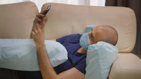 Stock Video Man With Covid Lays On Sofa With Mobile Phon Animated Wallpaper - Free Live Wallpaper