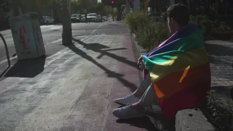 Stock Video Man With A Rainbow Flag Sits On The Stree Animated Wallpaper - Free Live Wallpaper