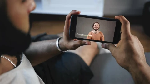 Stock Video Man Watches Social Media Video On Mobile Scree Animated Wallpaper - Free Live Wallpaper