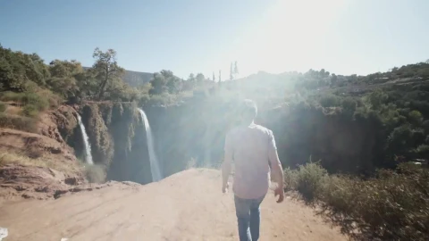 Stock Video Man Walks To A Deep Canyon With Waterfall Animated Wallpaper - Free Live Wallpaper