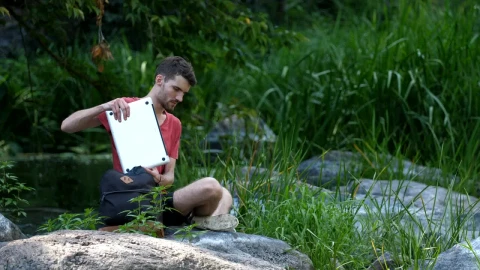 Stock Video Man Using A Laptop By A Strea Animated Wallpaper - Free Live Wallpaper
