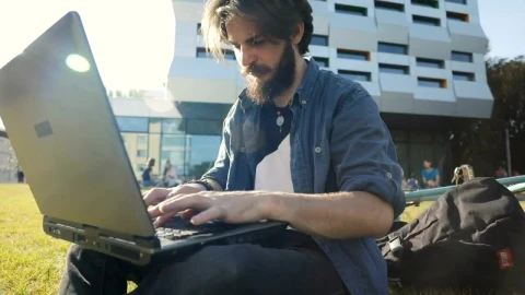 Stock Video Man Typing On Laptop Outside Smiles In Triump Animated Wallpaper - Free Live Wallpaper