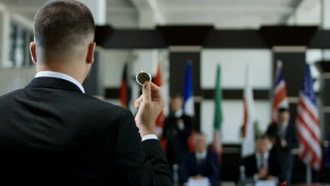 Stock Video Man Talking With A Coin In His Han Animated Wallpaper - Free Live Wallpaper