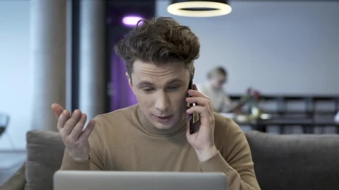 Stock Video Man Talking On The Phone While Working On The Compute Animated Wallpaper - Free Live Wallpaper