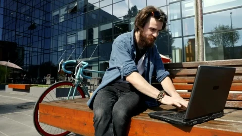Stock Video Man Surfs Internet On Laptop From Street Benc Animated Wallpaper - Free Live Wallpaper