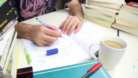 Stock Video Man Studying With A Cup Of Coffee And Many Book Animated Wallpaper - Free Live Wallpaper