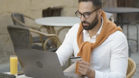 Stock Video Man Shops Online In Cafe And Pays With Credit Car Animated Wallpaper - Free Live Wallpaper