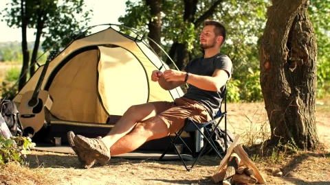 Stock Video Man Relaxing In His Camp In Natur Animated Wallpaper - Free Live Wallpaper