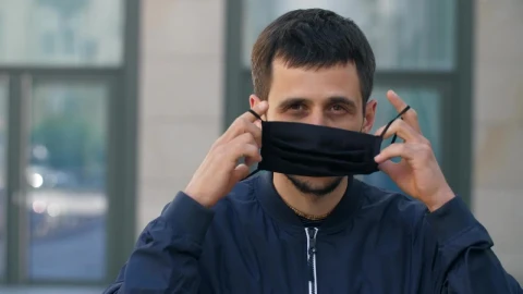 Stock Video Man Puts On A Black Face Mask On The Stree Animated Wallpaper - Free Live Wallpaper