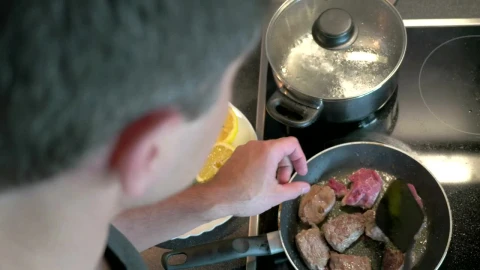 Stock Video Man Preparing Beef In A Frying Pa Animated Wallpaper - Free Live Wallpaper