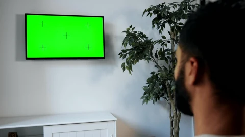 Stock Video Man Points Remote At Green Screen Tv On Wal Animated Wallpaper - Free Live Wallpaper