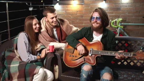 Stock Video Man Plays Guitar For Friends On Relaxing Evenin Animated Wallpaper - Free Live Wallpaper