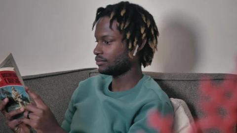 Stock Video Man On A Sofa Listening To Music And Reading Animated Wallpaper - Free Live Wallpaper