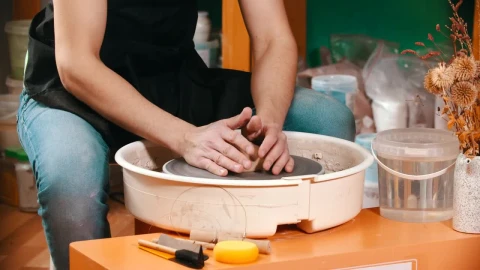 Stock Video Man Molding Clay On The Spinning Whee Animated Wallpaper - Free Live Wallpaper