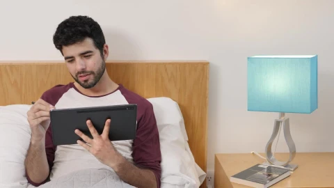 Stock Video Man Lying On Bed Drawing On A Table Animated Wallpaper - Free Live Wallpaper