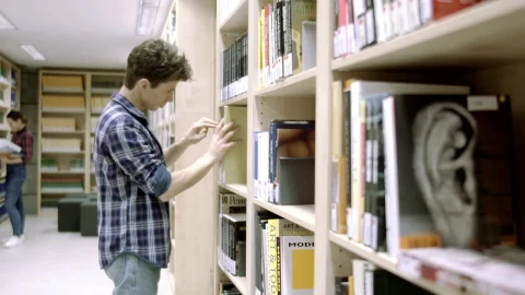 Stock Video Man Looking For A Book In The Librar Animated Wallpaper - Free Live Wallpaper