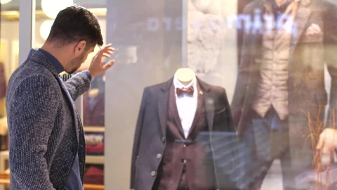 Stock Video Man Looking At The Sideboard Of A Suit Stor Animated Wallpaper - Free Live Wallpaper