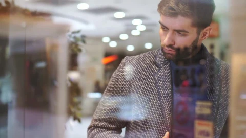 Stock Video Man Looking At The Sideboard Of A Clothing Stor Animated Wallpaper - Free Live Wallpaper