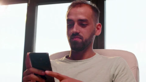 Stock Video Man Looking At His Cell Phone While Smilin Animated Wallpaper - Free Live Wallpaper