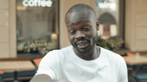 Stock Video Man Laughs At Facebook Video Call Outside Caf Animated Wallpaper - Free Live Wallpaper