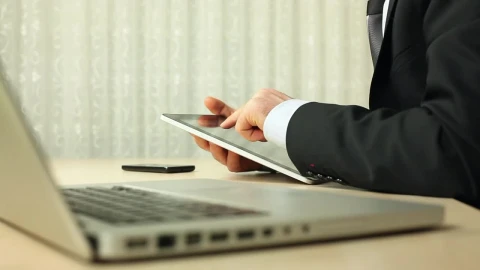 Stock Video Man In Suit Using A Tablet Next To His Compute Animated Wallpaper - Free Live Wallpaper