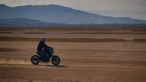 Stock Video Motorcyclist Crossing A Desert Surrounded By Mountains Live Wallpaper - Free Live Wallpaper