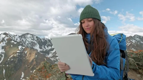 Stock Video Mountaineer Girl Using A Tablet In The Mountains Live Wallpaper - Free Live Wallpaper