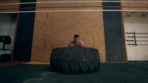 Stock Video Muscular Man Doing Crossfit Exercises With Tire Live Wallpaper - Free Live Wallpaper