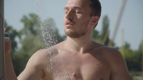 Stock Video Muscular Man In Outdoor Beach Shower Live Wallpaper - Free Live Wallpaper