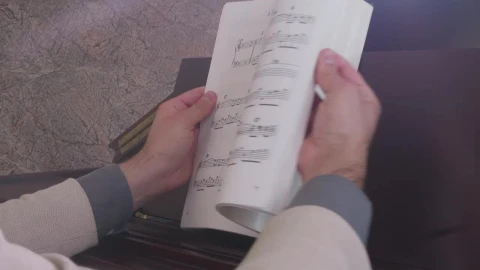 Stock Video Musician Looking For A Page In A Score Book Live Wallpaper - Free Live Wallpaper