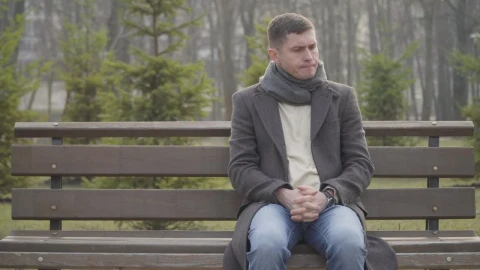 Stock Video Nervous Man Sits On Park Bench Waiting Live Wallpaper - Free Live Wallpaper