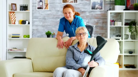 Stock Video Nurse Stands With Elderly Patient Sitting On Sofa Live Wallpaper - Free Live Wallpaper