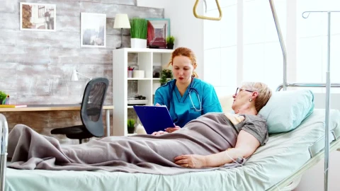Stock Video Nurse Talks With Woman Laying In Hospital Bed Live Wallpaper - Free Live Wallpaper