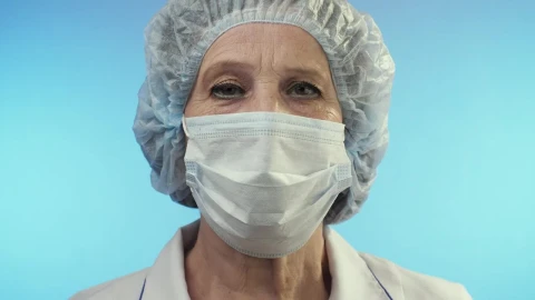 Stock Video Old Female Doctor Wearing Face Shield From Surgery Live Wallpaper - Free Live Wallpaper