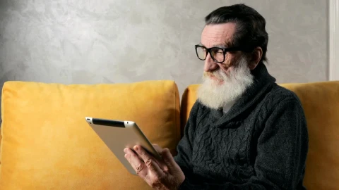 Stock Video Old Man Answers Mobile Phone Call While On Tablet At Live Wallpaper - Free Live Wallpaper